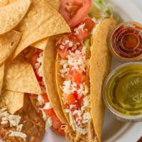 Taco Plate · Two tacos served soft or crispy with your choice of meat, served with beans and rice.