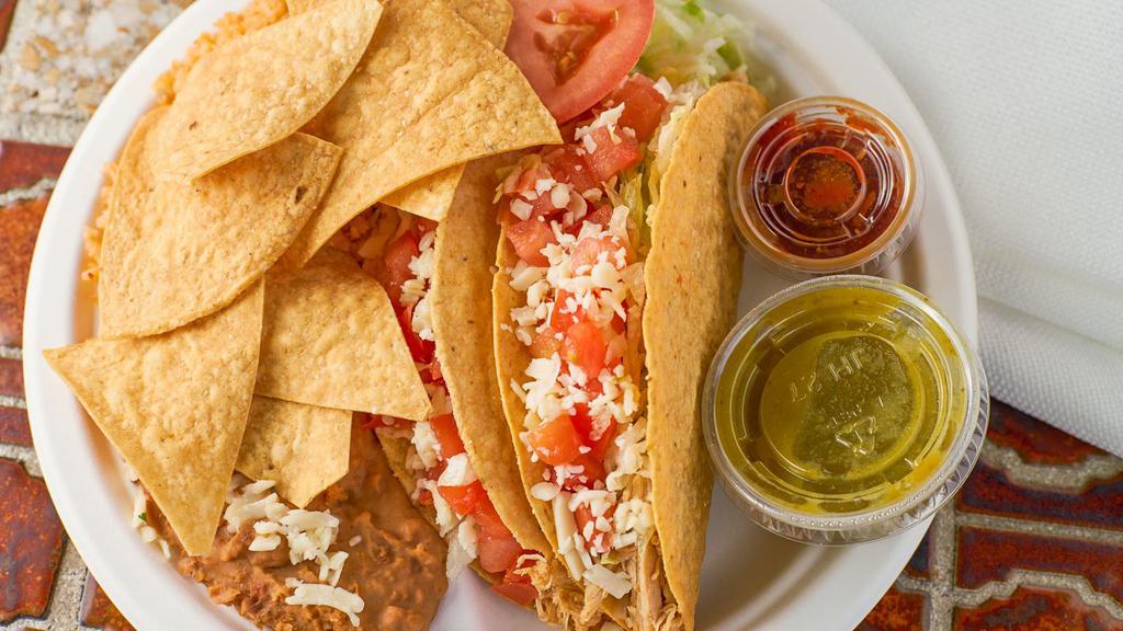 Taco Plate · Two tacos served soft or crispy with your choice of meat, served with beans and rice.