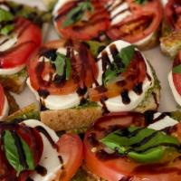 Bruschetta Caprese · Two slices of sourdough bread, topped with pesto, fresh mozzarella, tomato, fresh basil, and...