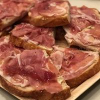 Bruschetta Prosciutto · Slices of sourdough bread, topped with garlic creamy cheese spread, prosciutto, and honey dr...