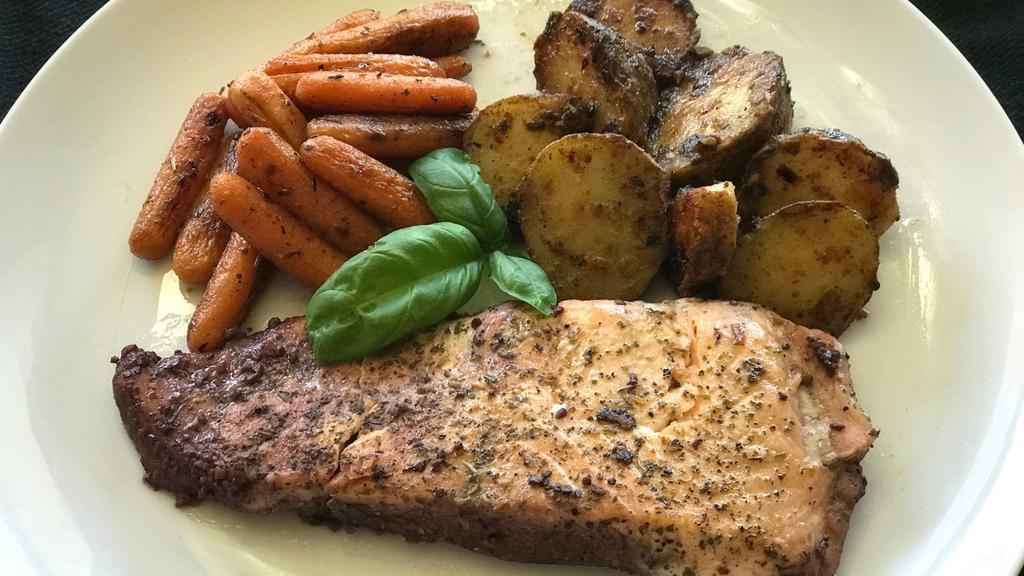 Seared Salmon · Slow-cooked in garlic wine then seared, served with roasted potatoes and baby carrots. This dish is gluten free.