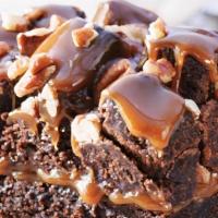Rockslide Brownie · A light textured Brownie topped with butter-luscious caramel, piled high with Brownie cubes,...