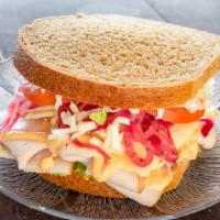 Baja Chipotle Turkey Sandwich · Thin slices of smoked turkey breast with a flavorful chipotle honey lime yogurt sauce, shave...