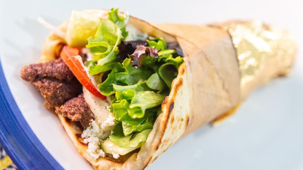 Beef/Lamb Gyro 🐄🐑 · Served in a toasted handmade pita with house made tzatziki sauce, onion, organic mixed greens, grape tomato, English cucumber, and feta cheese.