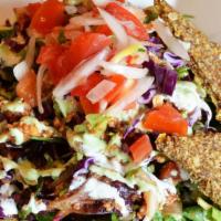 Taco Salad · Leafy greens tossed with enchilada dressing, layered with seasoned walnut meat, pico de gall...