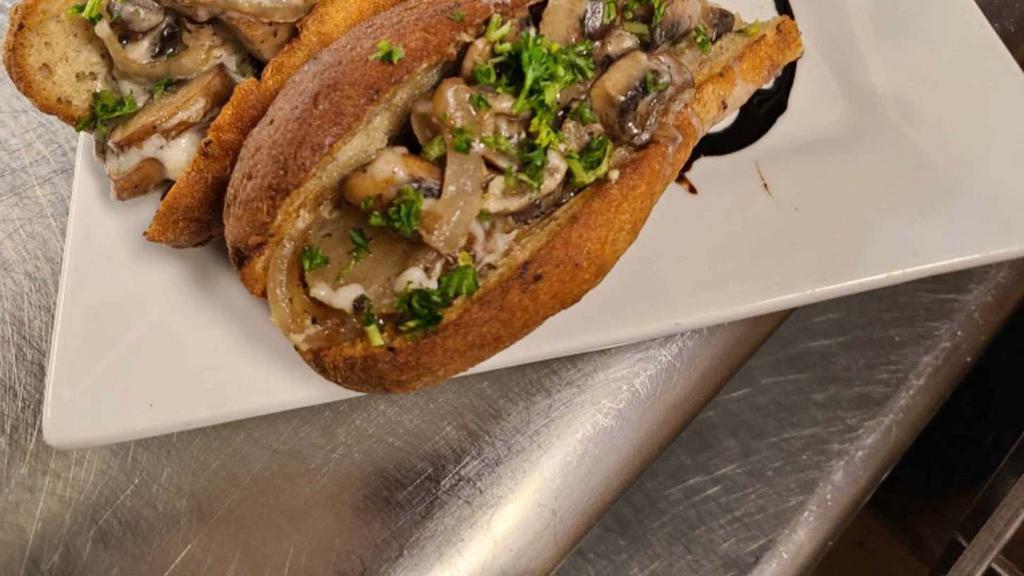 Mushroom Melt · A savory, smoky mixture of tempeh, mushrooms and onion on a toasted baguette with melted mozzarella. Served with a side of dipping au jus. (SOY)