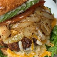 Black Bean Burger · A house-made black bean burger patty topped with grilled onions, lettuce, tomato, sliced avo...
