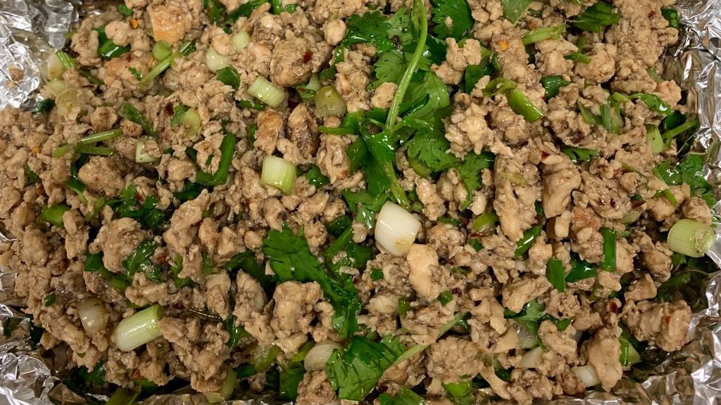 Larb Chicken Salad (Thai Lettuce Wraps) · Minced chicken mixed with lime, toasted rice, green onion, cilantro and chili served with lettuce.