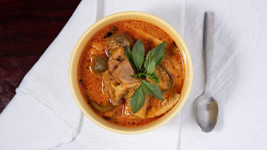 Red Curry Chicken · Red curry paste cooked with bamboo shoot, Thai eggplant, long bean, Thai basil, and coconut milk.