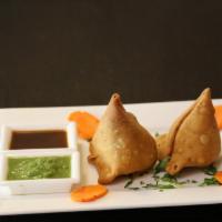 Vegetable Samosas · Two deep fried pastries with mildly spiced potatoes and peas.