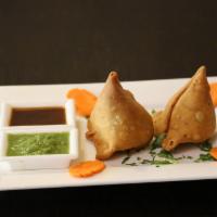 Lamb Samosas · Two deep fried pastries with mildly spiced ground lamb.
