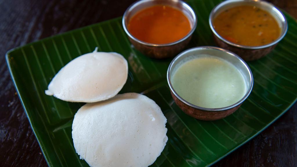 Idli Sambar · Two steamed rice cakes with lentil soup.