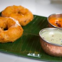 Vada Sambar · Two deep fried lentil pastries with lentil soup.