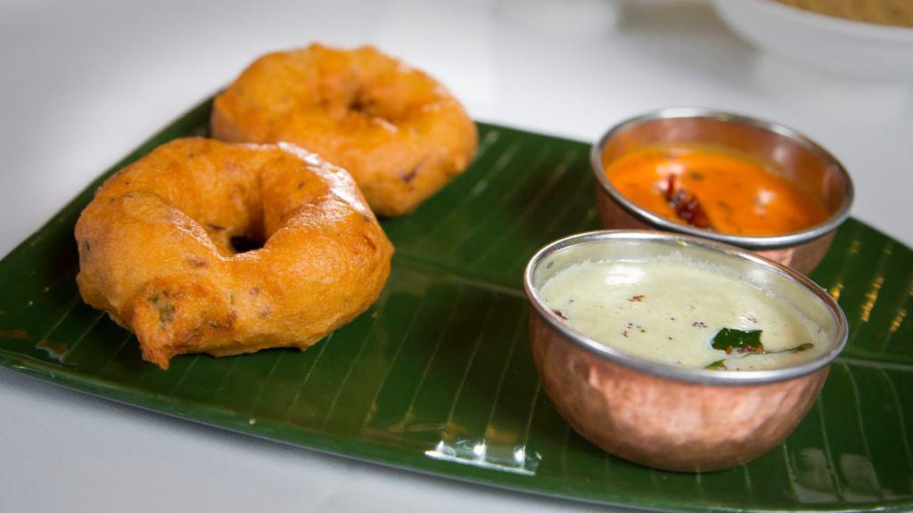 Vada Sambar · Two deep fried lentil pastries with lentil soup.