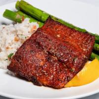 Cajun Oven Roasted Salmon · Blackened salmon with confit garlic butter, spring onion rice and seasonal vegetables.