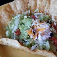 Taco Salad · Large crisp Tortilla Bowl filled with Fresh shredded Lettuce, Tomato, Green onions and Black...