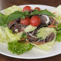 Yum Neau (Beef) · Grilled sliced beef tossed with red onion, cucumber, tomatoes, green onion and cilantro.