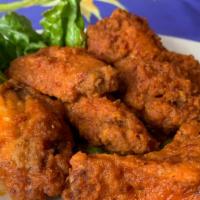 Buffalo Wings · Breaded and fried wings tossed in a spicy buffalo hot sauce and served with a side of ranch ...