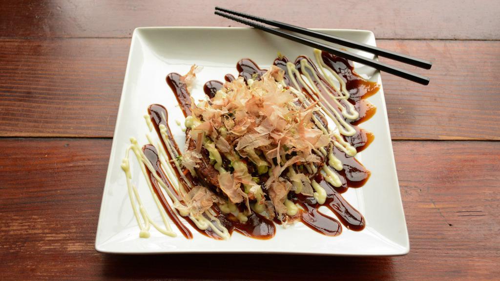 Okonomiyaki · Japanese vegetable pancake. Takoyaki sauce. mayo. mixed green salad and bonito flakes.