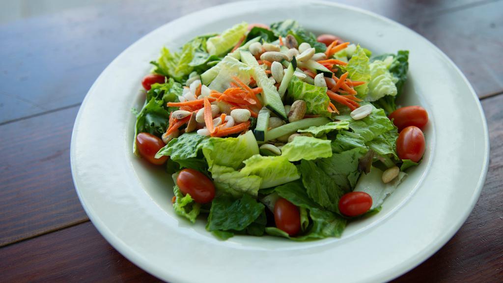 House Salad · Mixed greens, daikon, carrots, tomatoes, cucumber, peanuts. Served with creamy sesame dressing on the side.