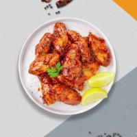 Sweet Blazing Wings · Breaded or naked fresh chicken wings, fried until golden brown, and tossed in honey & hot sa...
