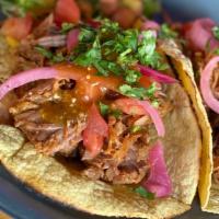 Oven Roasted Pork Carnitas · Cascabel salsa, tomatoes, cilantro, pickled red onions.