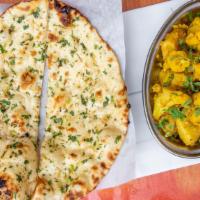 Aloo Gobhi · Cauliflower with potato cooked with ginger and herbs.