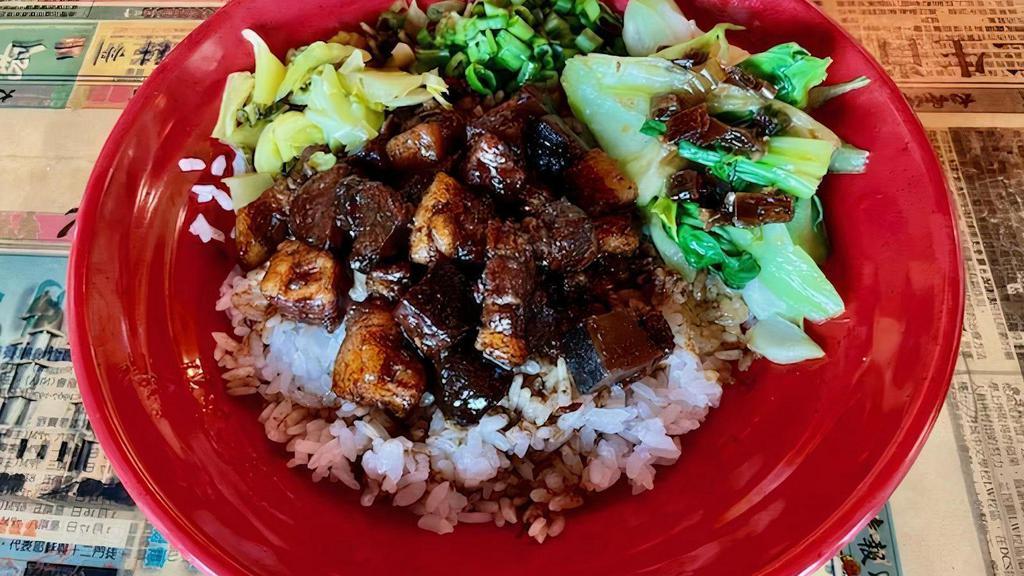 Lu Ro Fan · Pork belly braised in a decadent soy glaze, served with bok choy and green onions over aromatic rice.