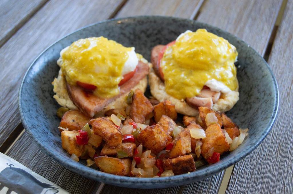 Green Eggs & Ham · Sliced smoked ham, fresh tomatoes, poached eggs over buttermilk biscuits, topped with green chili hollandaise sauce. Served with breakfast potatoes