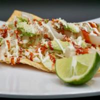 Chilindrina · Pork Skin or Chicken on a Duros Pellet served with Mayo, Onion, Cabbage, Tomato, Cilantro, C...
