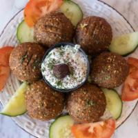 Falafel Over Salad · Romaine lettuce mix with green, red cabbage slices of tomato and cucumber, green pepper dill...