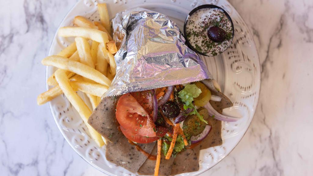 Lamb Gyro Combo · Sliced lamb on grilled pita bread with tzatziki, tomato, onion, cucumber and lettuce. Served with hummus, garlic sauce and fries.
