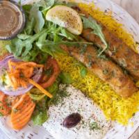 Chicken Kebab Over Rice · Two skewers of iraqi kebab chicken comes with the sauce of tzatziki and house salad dressing...