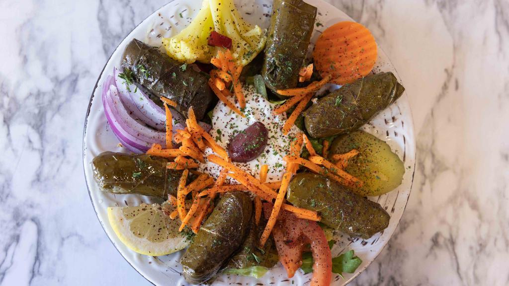 Vegetarian Grape Leaves Side Plate · Gluten free and vegan. Vegetarian rolled grape leaves stuffed with rice, tomato, onions, parsley and top garnish.