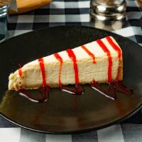 Cheesecake · Drizzled with raspberry sauce.