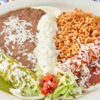 Trio Enchiladas · One shredded chicken enchilada topped with our jalapeño cream cheese sauce, one shredded bee...