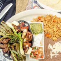 Molcajetito · Prepared with carne asada, chicken, chorizo, and cactus. Topped off with grilled onions, que...