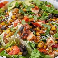 Fiesta Salad · Romaine lettuce, a mix of roasted corn, black beans, and pico. Topped off with avocado slice...