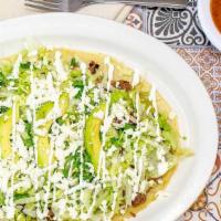 Huaraches · 10 inch long Corn Masa tortilla topped with re-fried pinto beans, poblano green salsa, lettu...