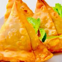 Vegetable Samosa · A special dough pastry stuffed with potatoes, peas, and five different spices. (2 pieces/ord...