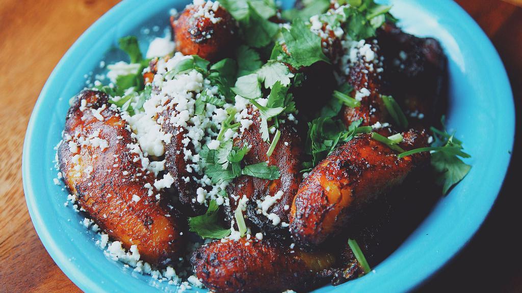 Fried Plantains · Topped with cilantro lime verde sauce, queso fresco and cilantro.