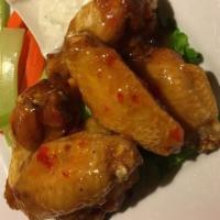 Spicy Thai Wings (6 Pieces) · Deep-fried crispy breaded chicken wings are stir-fried with cilantro green onion and thai ch...