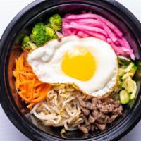 Bibimbap (비빔밥) · A bowl of warm white rice topped with namul- vegetables and sesame oil with gochujang or soy...