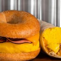 Ham, Egg & Cheese Sandwich · Thinly sliced ham and fluffy eggs covered with cheese served on bagel or croissant. Made fre...