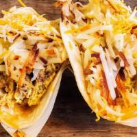 Breakfast Tacos · 2 corn tortillas tacos with your choice of meat, hash browns and scrambled egg.
