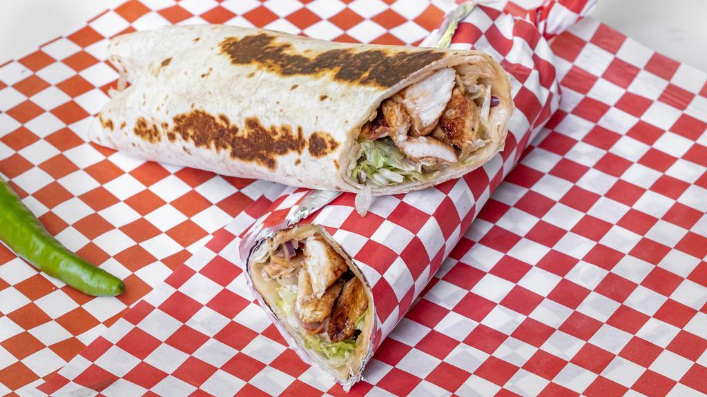 Chicken Saj · Chicken shawarma, hummus, lettuce, tomatoes, pickles, fresh onions, topped with house garlic sauce rolled with Saj bread seared on all sides. Extra meat for an additional charge.