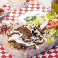 Lamb Gyro Combo · Well, seasoned lamb gyro cooked on the top griddle, on a bed of basmati rice topped with hou...