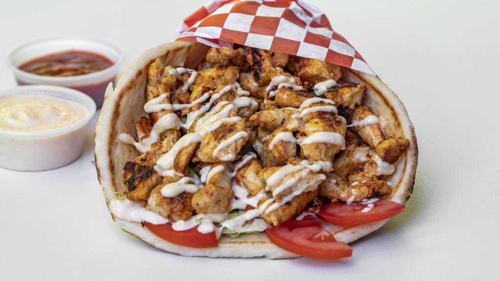 Chicken Shawarma Gyro · Seared shawarma chicken rolled with pita bread pita, lettuce, tomatoes, pickles, onions hummus, topped with in-house garlic sauce. Extra meat, extra garlic sauce & hot sauce for an additional charge.