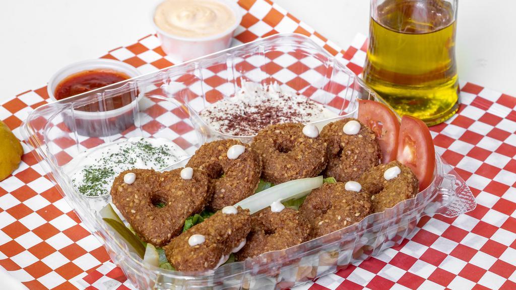 Falafel Combo · 8 pieces of falafel on a bed of salad two sides, hummus, tzatziki. Add extra pieces of Falafel for an additional charge.