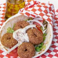 Falafel Gyro · 5 pieces falafel rolled with bread pita lettuce, tomatoes, pickles, onions, hummus, and tzat...